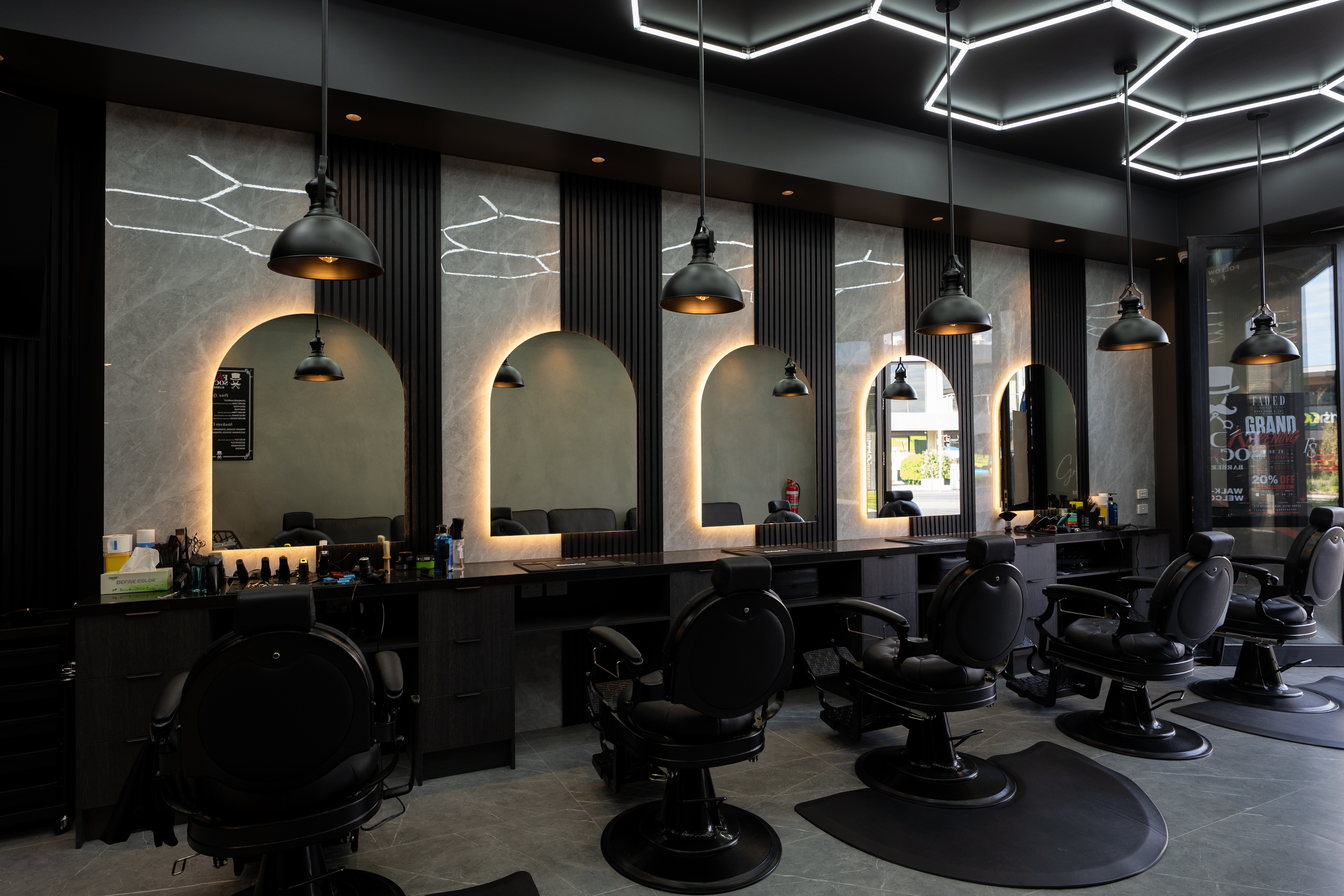 Barber chairs and mirrors inside Faded Society barbershop, Clyde North